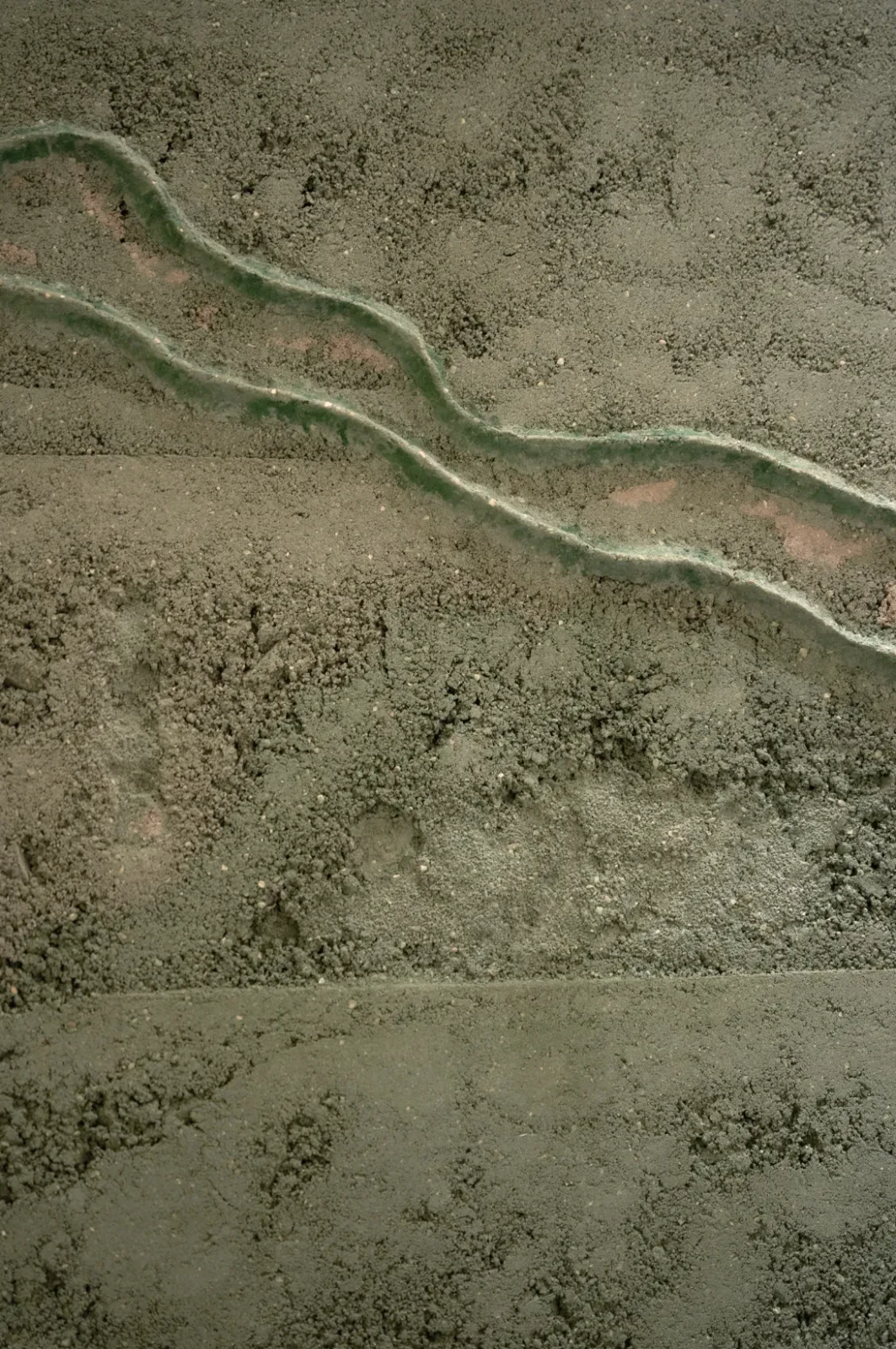 Close-up of Terre Verte by Adam Weismann showing two glassy green ridges crossing the earth surface