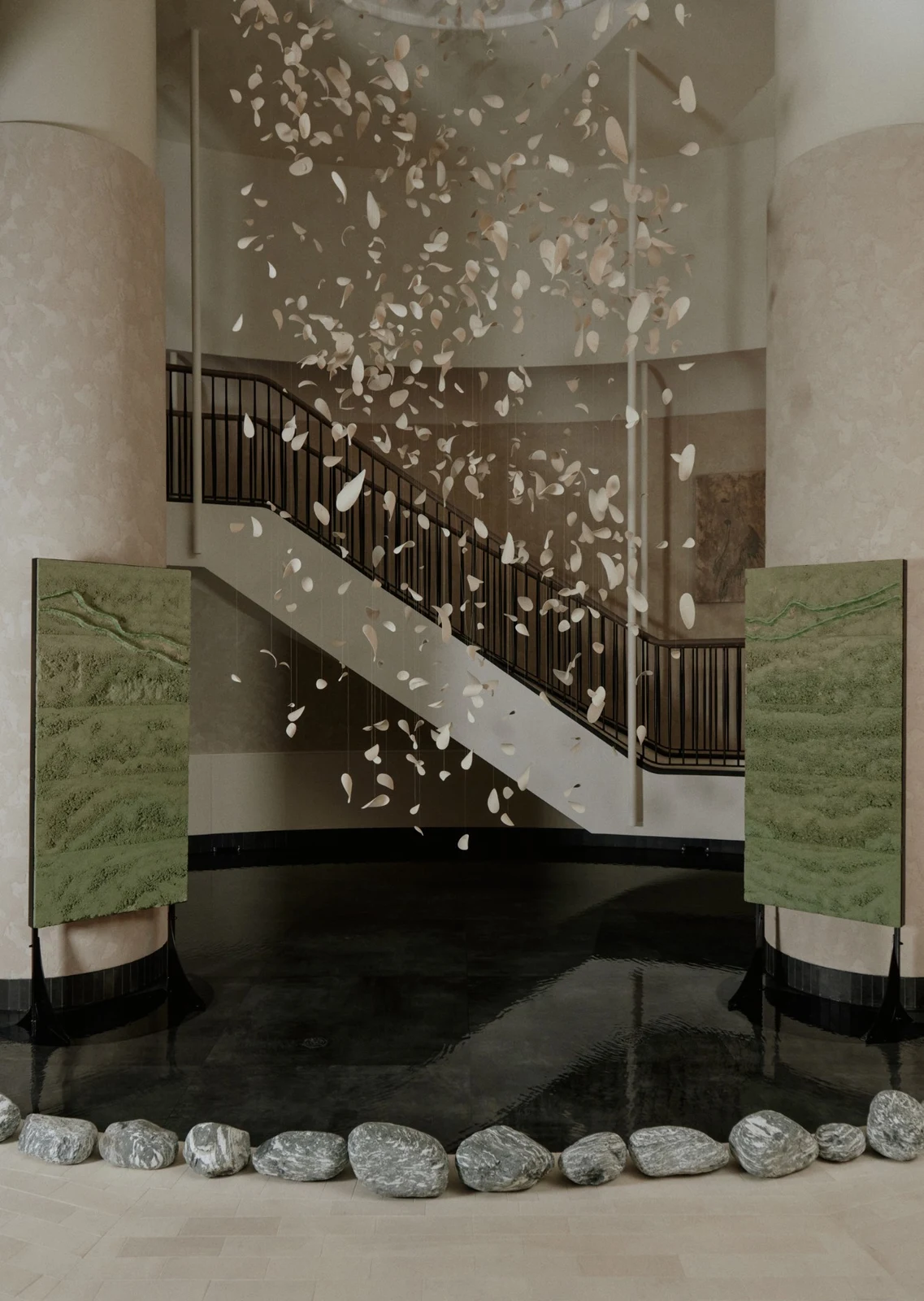 Two Terre Verte panels by Adam Weismann standing either side of a dark pool beneath a suspended petal installation