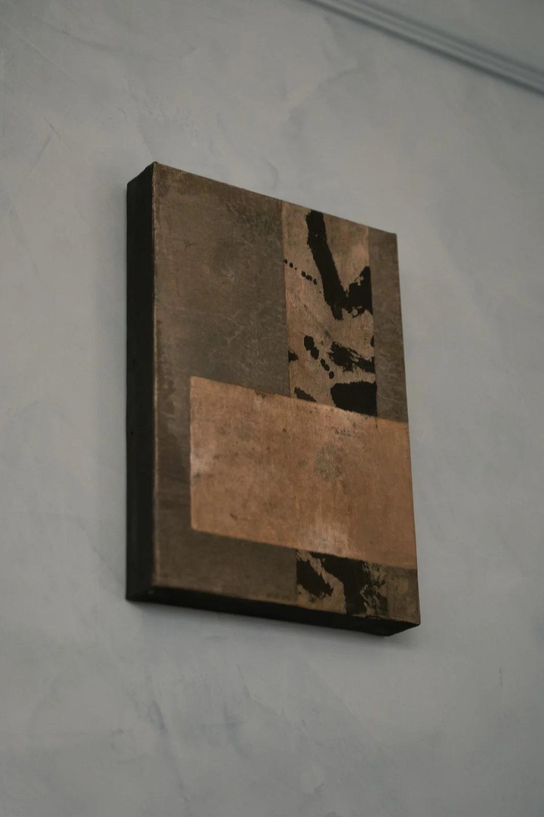 Untitled (GES#5) by Alexandra Yan Wong, seen at an angle on a blue plaster wall, showing the canvas edge
