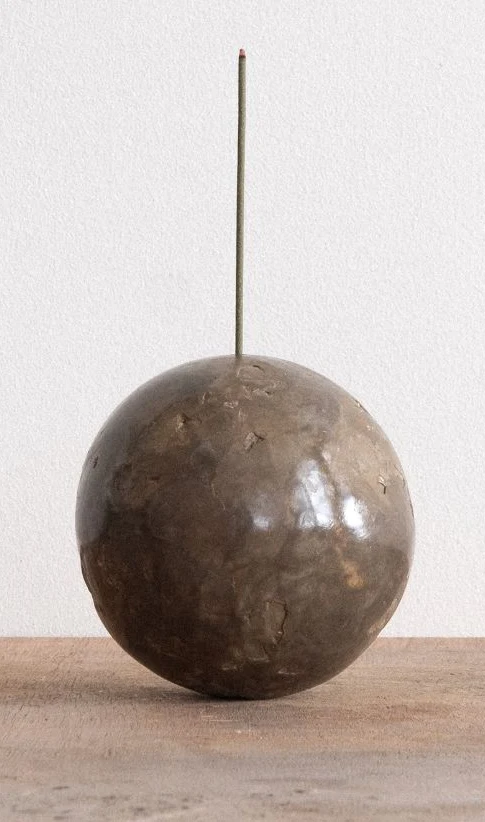 Incense Ball by Arran Gregory, a burnished clay sphere holding a single upright incense stick