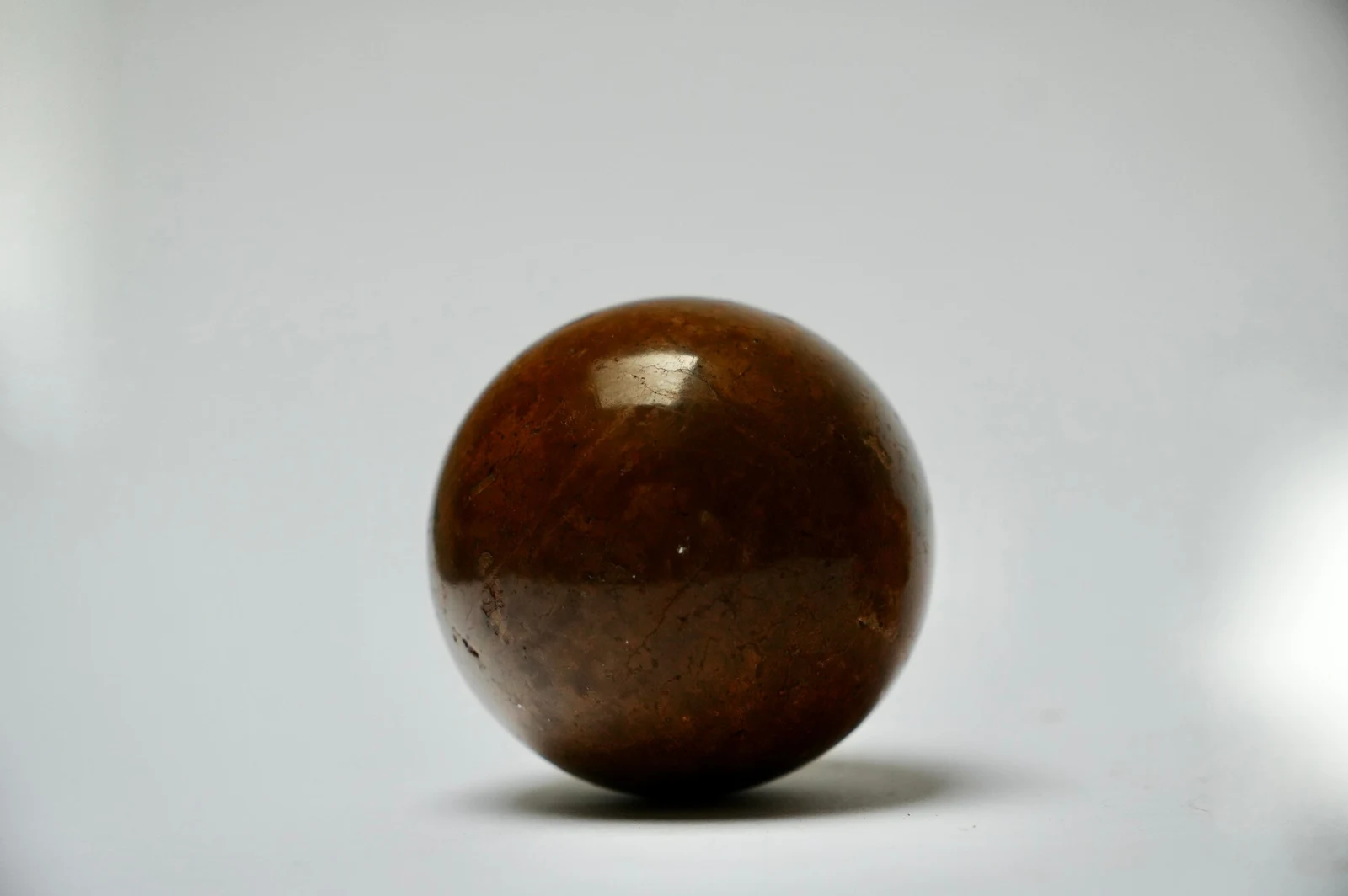 Dorodango Pair I by Edie Evans, close-up of the polished sphere