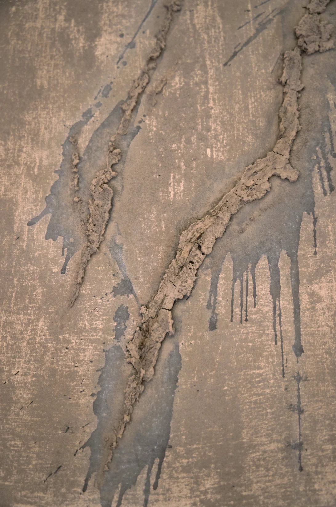 Close-up of Unearthing Series #1 by Eleanor Herbosch showing ridges of raised London Clay and grey drips across the canvas