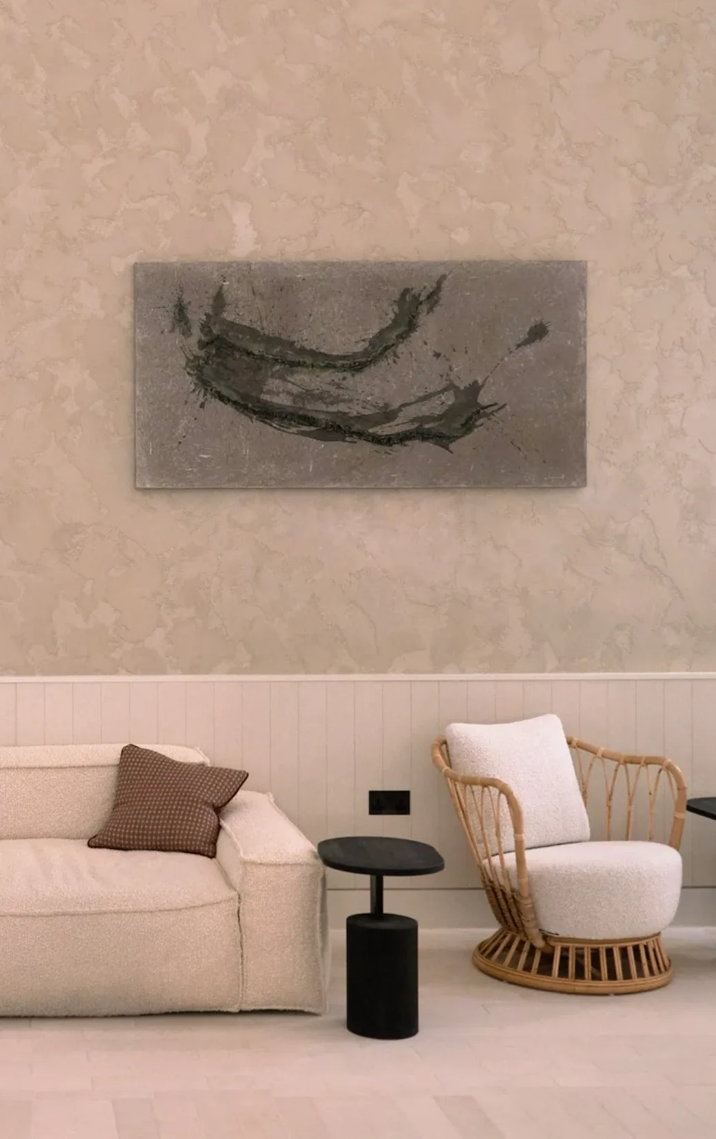 Unearthing Series #3 by Eleanor Herbosch hanging on a plaster wall above a cream sofa, black side table and rattan armchair