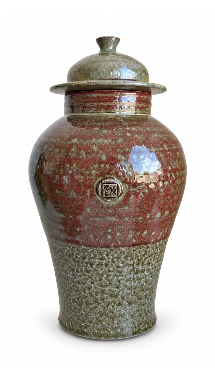 Ginger Jar by Jacob Chan, a lidded jar with a glossy red shoulder above a speckled green base