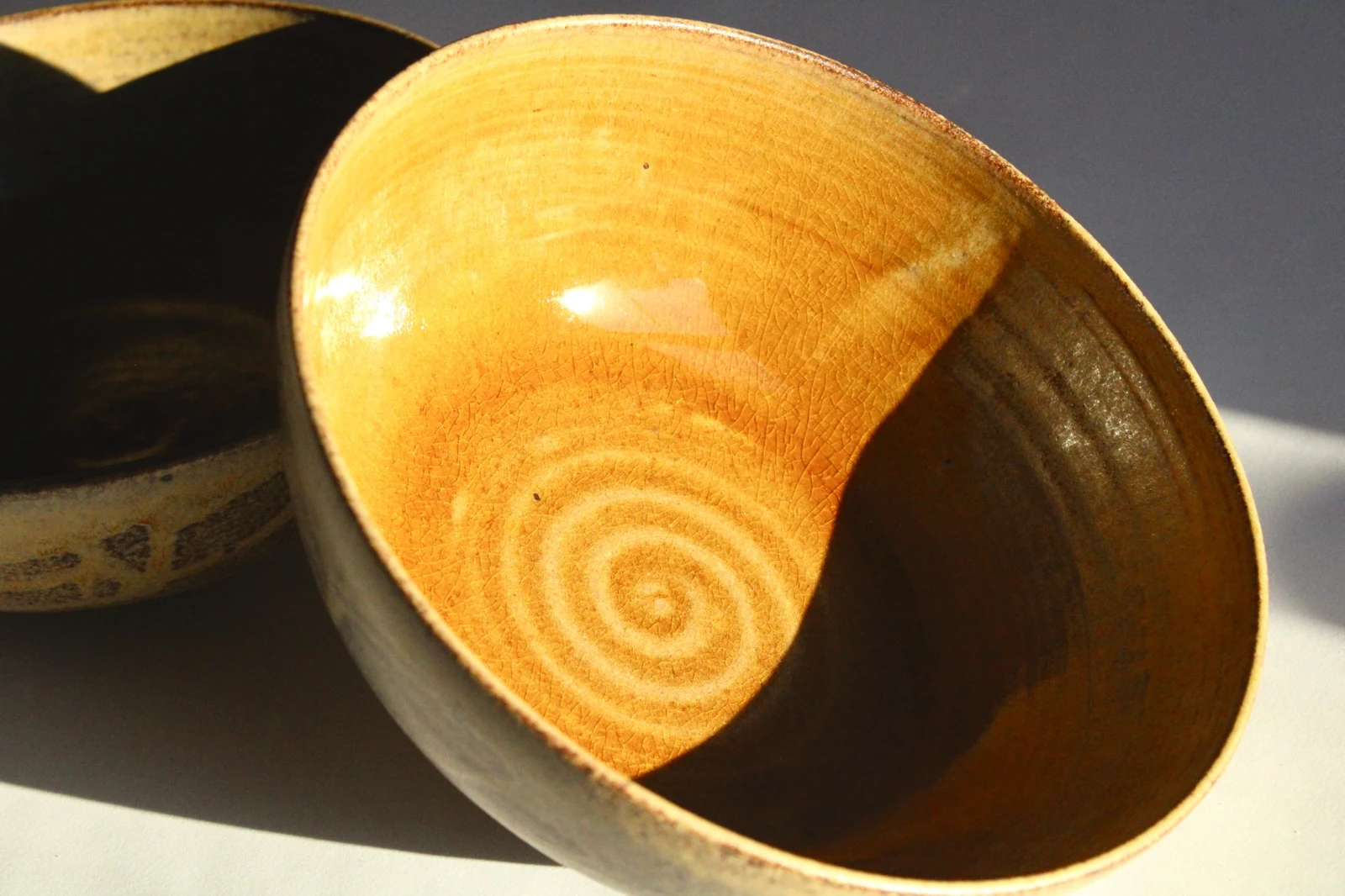 Inside Large Bowl by James Galbraith Kirkpatrick, a crackled amber glaze with throwing rings