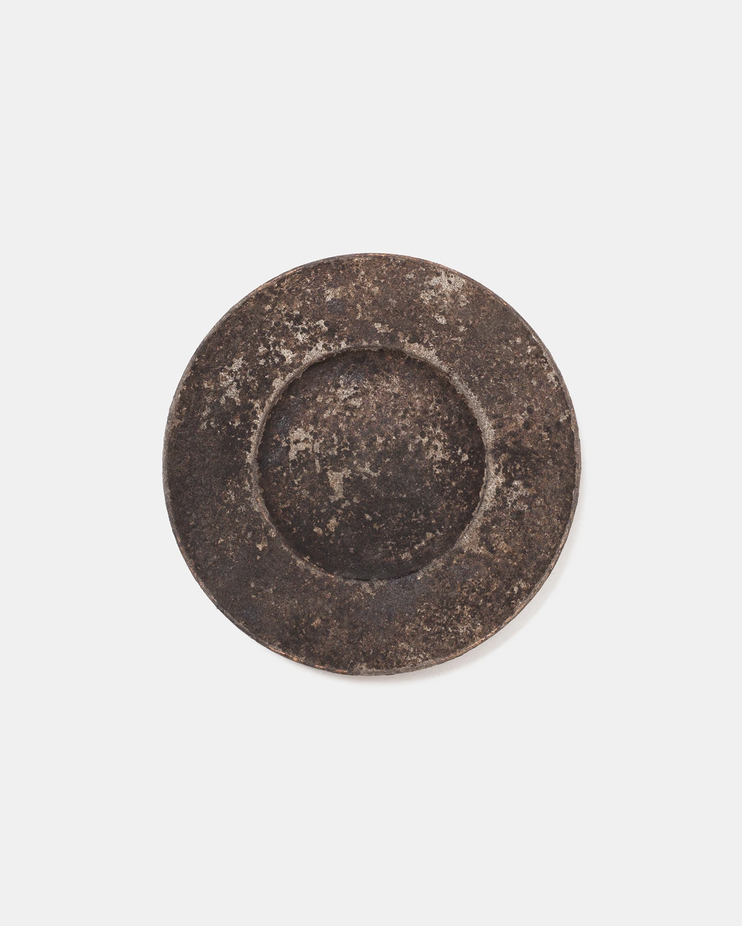 Plate II by Louis Vincent seen from above, a dark mottled plate with a wide rim and sunken centre