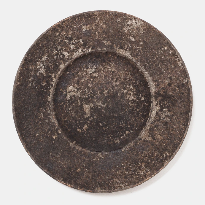 Plate II by Louis Vincent seen from above, a dark mottled plate with a wide rim and sunken centre
