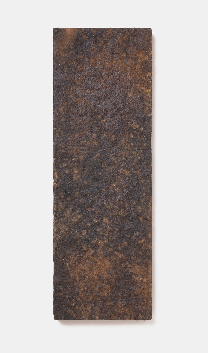 Wall Panel V by Louis Vincent, a dark brown panel with a rust-speckled textured clay surface