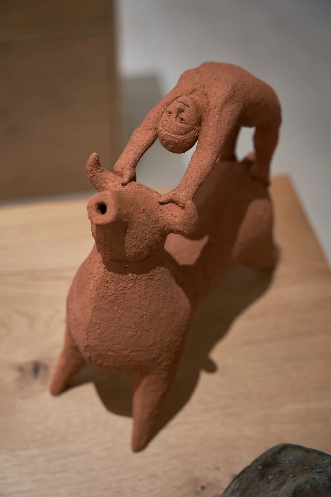 Bull Leaping II by Zahed Tajeddin seen from above, the figure arching over the bull's back to hold its horns