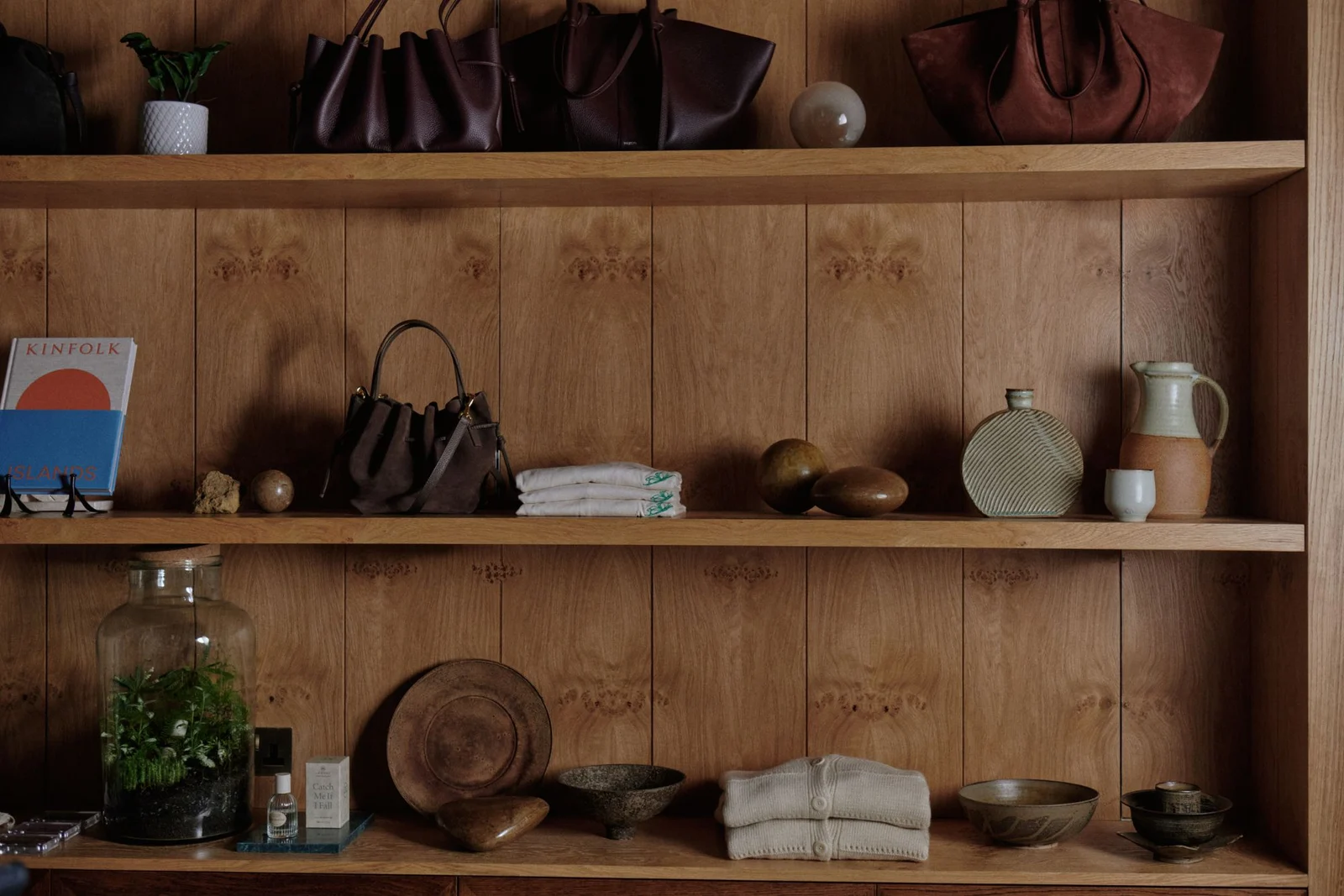 Ceramics, stones and vessels on oak shelves in Found, the boutique at Six Senses London